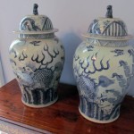 A pair of Oriental vases with original covers (250-350).