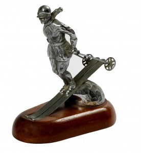 A nickel plated car mascot stamped Riley Ski Lady  (150-250).