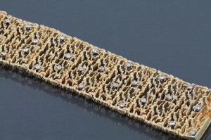 An 18 carat gold wide bracelet , mesh link by West of Dublin, set with diamonds  (4,000-5,000).