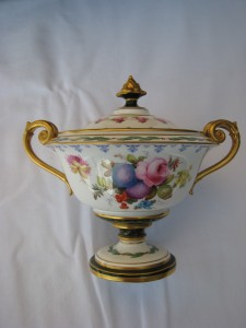 A Royal Crown Derby urn painted by Cuthbert Greasley c1913 at Brian Hurley's stand is priced at 550.