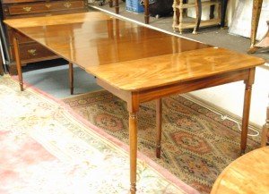 A Georgian dining table with three extra leaves (1,500-2,000).