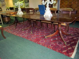 A three pillar dining table with two extra leaves (2,000-3,000)