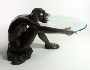 A bronze patio table modelled as  a seated nude (220-380).