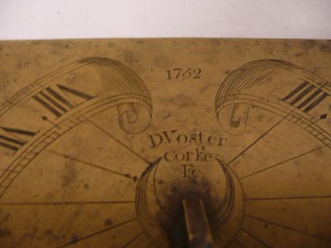 A detail of the sundial with the makers name and date.