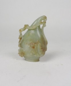 A small shaped carved jade vase.