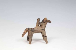 A GREEK BOEOTIAN SIXTH CENTURY B.C. TERRACOTTA MODEL OF A HORSE AND RIDER, decorated with dark brown painted stripes and spots. 10cm high Provenance: -Collection of Sir Clifford Norton (British Ambassador to Greece, stationed in Athens from 1946-1951)  (600-1,000)