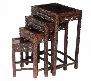 A carved Oriental nest of four tables (400-600).