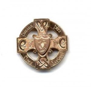 "The Son of Cuchulainn - Nicky Rackard" Medal: G.A.A. Hurling 1955, an attractive 9ct gold Celtic cross pierced Medal, the obverse with Celtic scroll design and inscribed "Cumann luith cleas Gaedheal," and "Eire" across the middle and a central harp overlay, the reverse inscribed "Craobh Iomana na hEireann 1955 - Loc gCarman - Nicky Rackard," hall marked J.M. (John Millar).