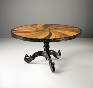 An Anglo-Indian Carved and Inlaid Rosewood, Ebony, Hardwood, Mahogany, Bone, and Ivory Parcel Gilt Circular Center Table Ceylon, circa 1830 ($40,000-60,000)