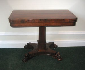 An Irish Regency fold over card table (1,500-2,500).