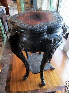 A Chinese hardwood stand with inset marble top.