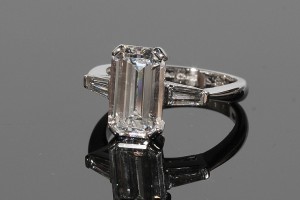 An emerald cut 3.31 carat F colour diamond solitaire ring (65,000-75,000).