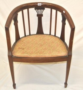 An Edwardian tub armchair (100-150).