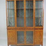 An exhibition quality inlaid satinwood breakfront display cabinet by James Hicks (7,000-10,000)
