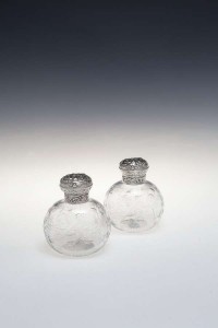 A pair of late Victorian moulded perfume bottles London 1892, mark William Comyns (150-250).