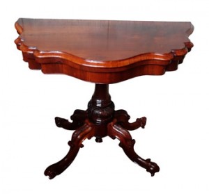 A serpentine front Victorian fold over card table (1,500-2,500).
