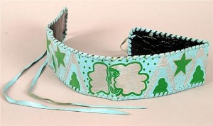 Jimi Hendrix, painted leather strap  A pale blue leather band decorated in emerald green and silver with stars and clouds and centred with a stylised woman's face. Accompanied by a letter, dated November 7, 2013, from Bob Levin, Jimi Hendrix's U.S. manager, stating that the strap was given to Jimi Hendrix by a fan and that he wore it "frequently around his thigh when he played". The letter also certifies that the item belonged to Jimi Hendrix. Also a photograph of Jimi Hendrix with Bob Levine and Steven Angel taken in New York, 8 November, 1968. 91,800-2,200)