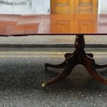 A 24 foot long mahogany dining table on four pods.