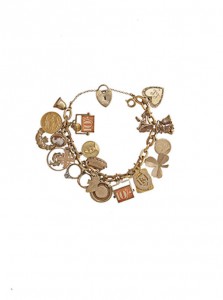 A 9 carat gold charm bracelet, the 18 carat gold fancy-link chain suspending numerous 9 carat gold charms (400-600).