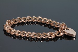 An antique gold curb link bracelet (350-400).