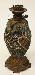 An unusual Doulton stoneware oil lamp made 1,955 at hammer.