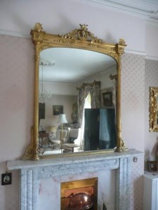 A gilt overmantle mirror.