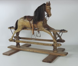 A pine rocking horse of small proportion (750-1,250).