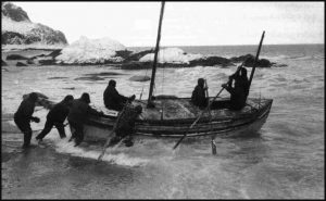 The James Caird being launched from the shore of Elephant Island in April 1916.