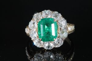 A certified Colombian emerald ring in diamond surround (10,000-12,000)